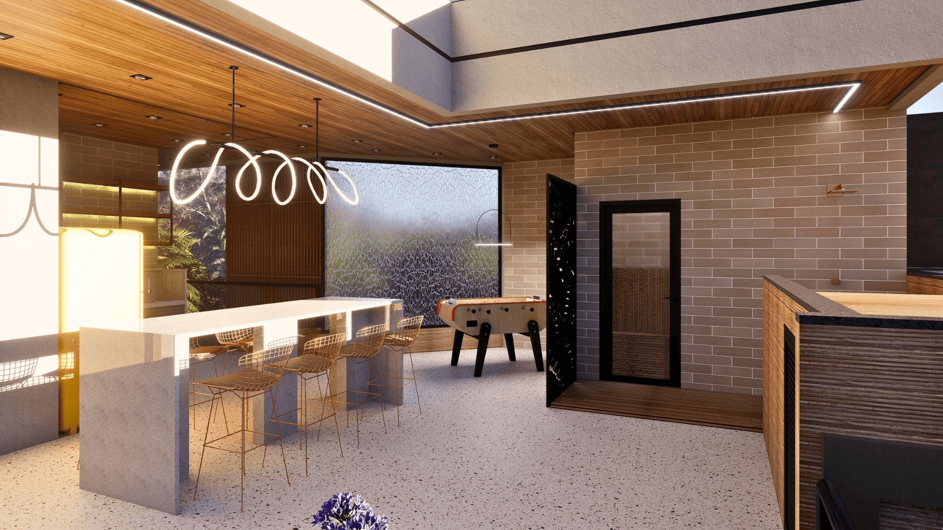 Espaço gourmet com bancada alta, pebolim e acesso à sauna